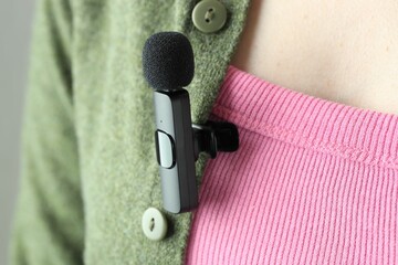 Woman with lavalier microphone on her shirt, closeup