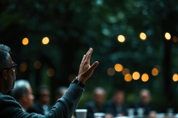 Man raising hand in outdoor meeting