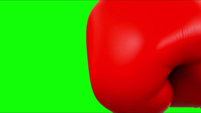 A red boxing glove against a green screen.