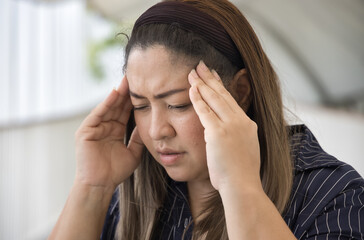 Serious and stressful middle age woman having stress-type headache and muscle tension health problem, concept image for physical and mental health care