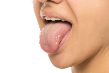Close-up of female mouth with tongue out, showing teeth and expressive gesture. Playful, candid...