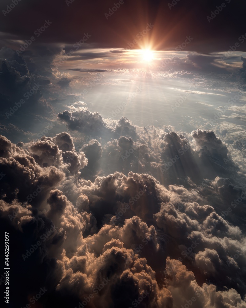 Poster dramatic aerial view of a sunset above a sea of clouds with sunbeams piercing through the cloudscape