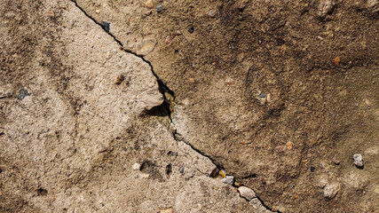 Crack on old grunge concrete wall covered with brown moss
