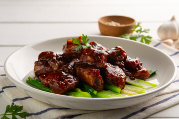 Close up Honey Braised Pork Baby Back Ribs or pork cartilage with soy sauce in white plate.