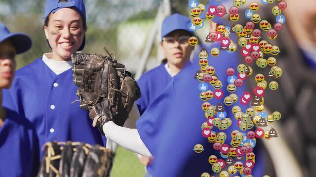 Female softball players posing on field, showing heart icon emoji overlay for sports marketing