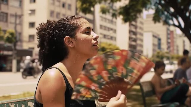 Woman suffering from heatwave in hot urban street in Brazil