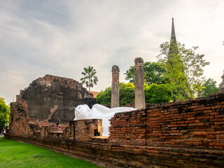 Wat Yai Chaimongkol, one of the UNESCO World Heritage place Ayudhaya, Thailand, ancient pagoda and buildings with surrounding a lot of buddha statues in outdoor under blue sky in summer