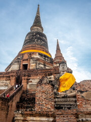 Wat Yai Chaimongkol, one of the UNESCO World Heritage place Ayudhaya, Thailand, ancient pagoda and buildings with surrounding a lot of buddha statues in outdoor under blue sky in summer