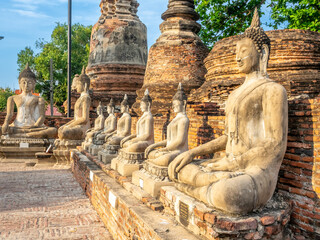 Wat Yai Chaimongkol, one of the UNESCO World Heritage place Ayudhaya, Thailand, ancient pagoda and buildings with surrounding a lot of buddha statues in outdoor under blue sky in summer