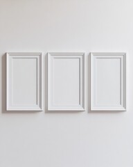 Three empty white frames arranged symmetrically on a light wall, creating a minimalist and elegant vibe.