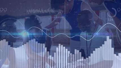 Sports team leaning over strategy board in gym mixing technology charts and waveform analytics - Powered by Adobe