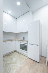 Fototapeta premium Modern White Kitchen Interior with Elegant Countertops and Appliances