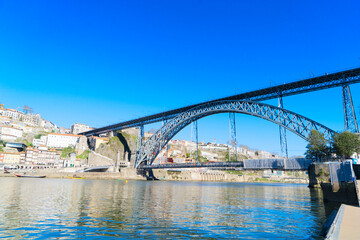 Picturesque, colorful view at old town Porto with famous bridge, Portugal with bridge Ponte Dom Luis over Douro river. Oporto, touristic mediterranean city
