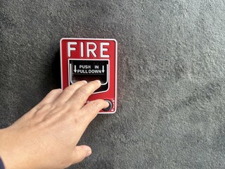 A hand was pulling down the fire call to fire alarm.