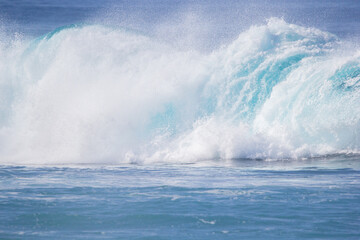 Crushing surf waves in crystal clear turquoise blue colour water close up