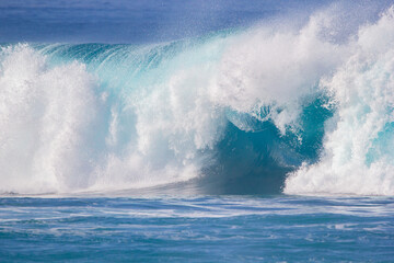 Crushing surf waves in crystal clear turquoise blue colour water close up