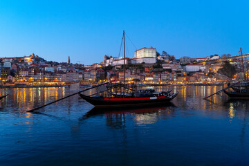 Fototapeta premium Picturesque, colorful view at old town Porto at sunset over Douro river. Oporto, touristic mediterranean city