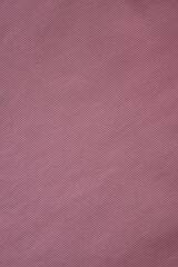 Fototapeta premium pink texture of knitted synthetic fabric as a background, pink smooth symmetrical lines of synthetic fabric 