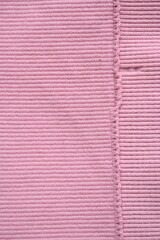  pink texture of knitted synthetic fabric as a background, pink smooth symmetrical lines of synthetic fabric 