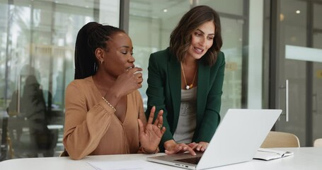 Young Latin business woman giving professional help, assistance to African colleague, showing web service, online product on laptop, typing, explaining application work