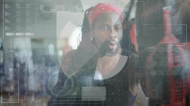 Male boxer throwing punch in gym, showing AR pie charts and line graphs for fitness tech