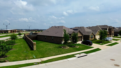 Close-up aerial view new construction home solar panel roof in rapid growing Princeton, Collin County, North Texas, clean energy efficiency home suburbs Dallas metroplex, upscale residential area