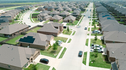 Peaceful residential street in new development area row of new construction houses solar roof in rapid growing Princeton, Collin County, Texas, clean energy efficiency home suburbs DFW metroplex