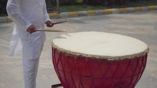 Mid Shot of Man Playing Indian Drum or Nagada