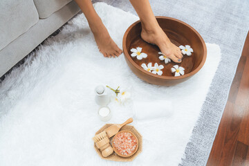 Panorama top view woman indulges in blissful foot massage at luxurious spa salon while masseur give reflexology therapy in gentle day light ambiance resort or hotel foot spa. Quiescent
