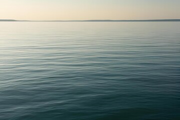 Obraz premium Close-up of calm, flat ocean surface under soft natural light