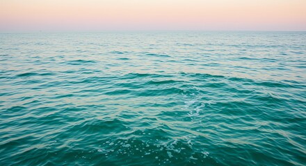 Obraz premium Calm Ocean Water with Gentle Waves at Dusk