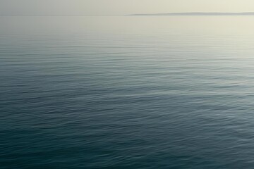 Obraz premium Close-up of calm, flat ocean surface under soft natural light