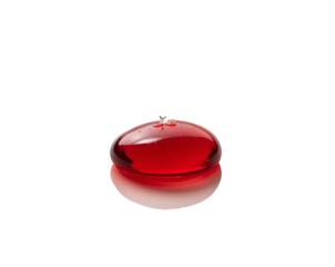 Isolated vibrant red fluid drop resting gently on a reflective surface, showcasing purity and scientific precision in a studio setting, evoking concepts of life and research