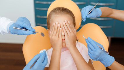 Healthy teeth, caries prevention and pediatric dentistry. Hands of medical workers in rubber gloves...