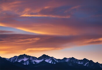 The sky glows warmly at sunset, casting soft light over the dark-colored mountain peaks.
