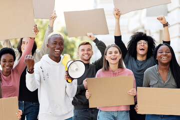 Furious multiracial students with empty placards having strike or demonstration on the street....
