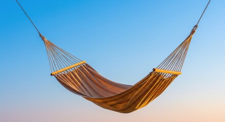 Hammock swinging gently against a clear blue sky  