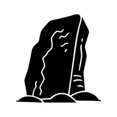 A monolithic stone standing tall on mounds of earth in silhouette form