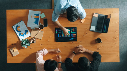 Top aerial view of business man present financial graph to group of smart investors. Professional...