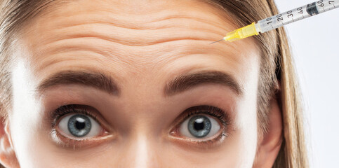 Cosmetologist does prp therapy on the face of a beautiful woman in a beauty salon. Women's...