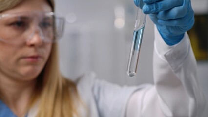 Scientist Examining Liquid in Test Tube with Focus and Precision