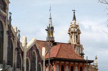 Naklejka premium March 27 2022 - Spain. A detailed view of the famous Mercado Central with its striking architecture and decorative towers in Valencia, showcasing European heritage and cityscape beauty.