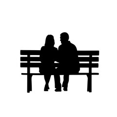 Silhouette of a couple sitting on a bench in a romantic scene