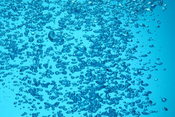 Many water bubbles on light blue background, closeup