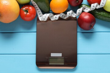 Electronic kitchen scale, measuring tape and products on light blue wooden table, flat lay. Diet