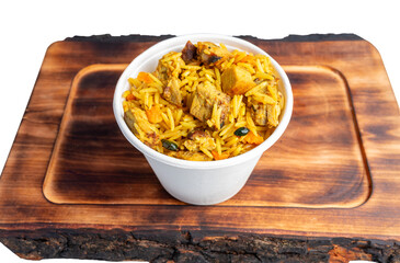 Delicious rice dish served in a bowl on a wooden tray