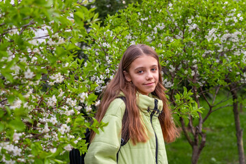 Spring Portrait: Young Girl Amidst Blossoming Trees in Full Bloom, Outdoor Scene
