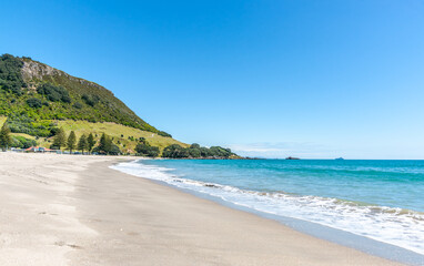 Long sandy Main Beach leading to Mount Maunganui