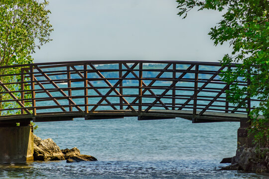 Wooden pedestrian bridge on lake Simcoe at Innisfil beach park, Ontario, Canada