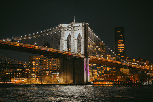 Fototapeta Brooklyn Bridge Illuminated at Night Over East River